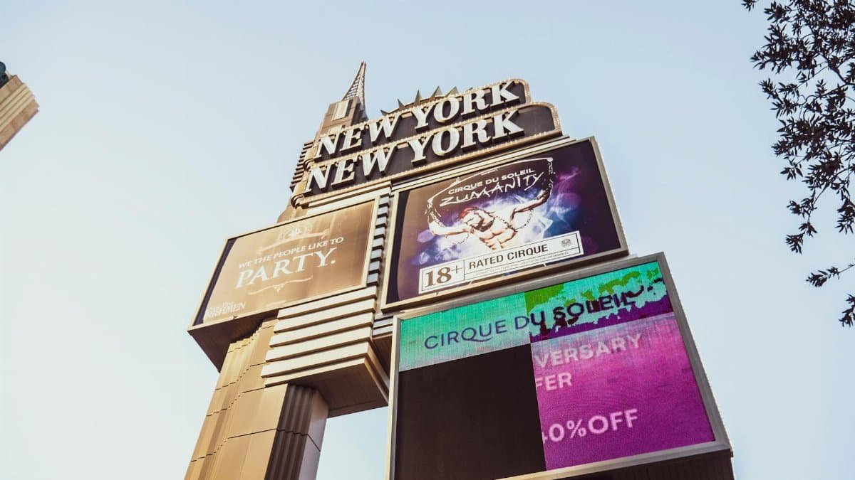 Iconic New York New York casino sign on the Las Vegas Strip showcasing Cirque du Soleil promotion.