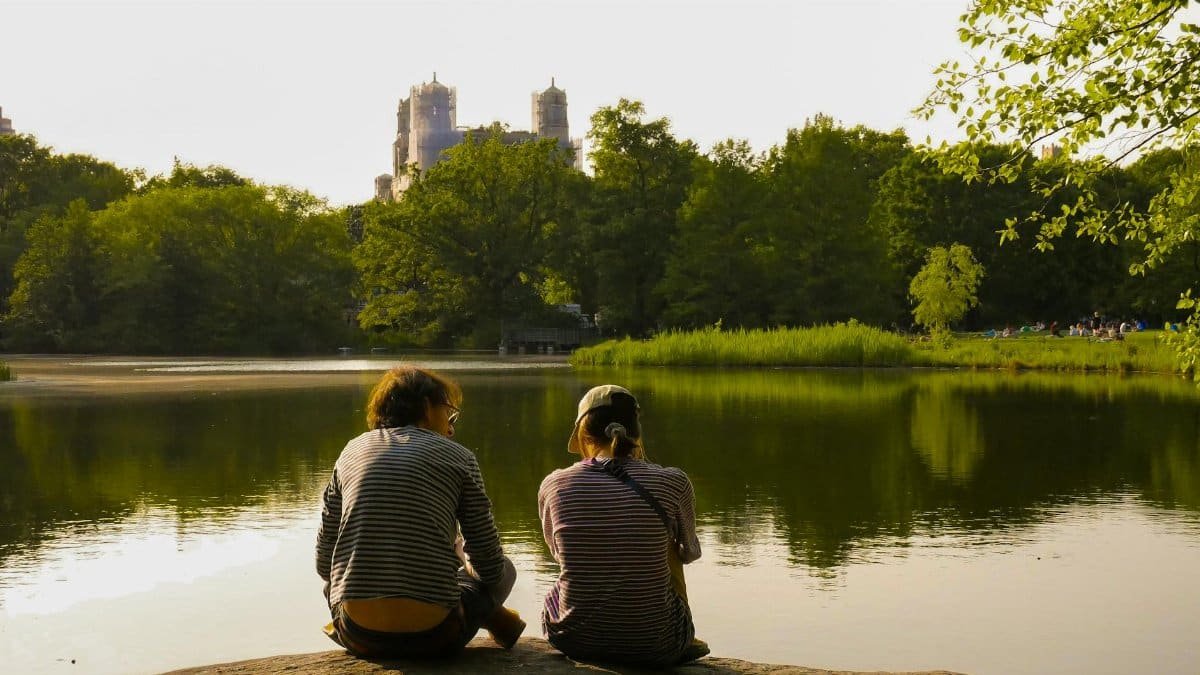 A couple enjoys a peaceful moment at Central Park Lake, New York City.