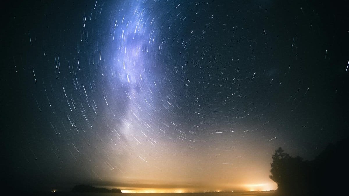 Beautiful long exposure of star trails over the New Zealand coast at night.