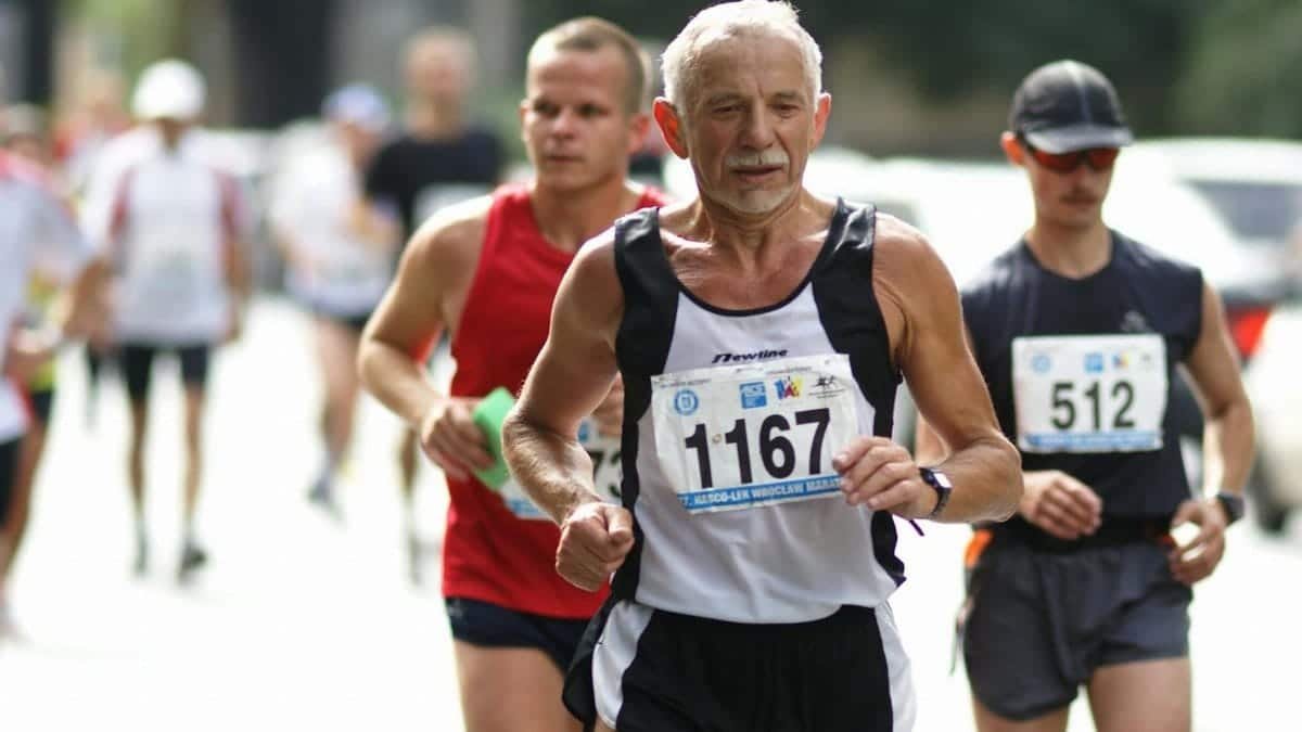 Group of determined marathon runners competing on the streets of Wrocław.