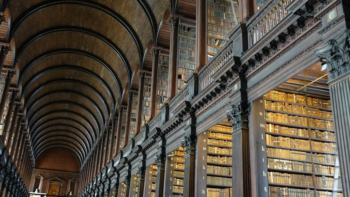 Expansive view of the historic Long Room library in Trinity College Dublin.