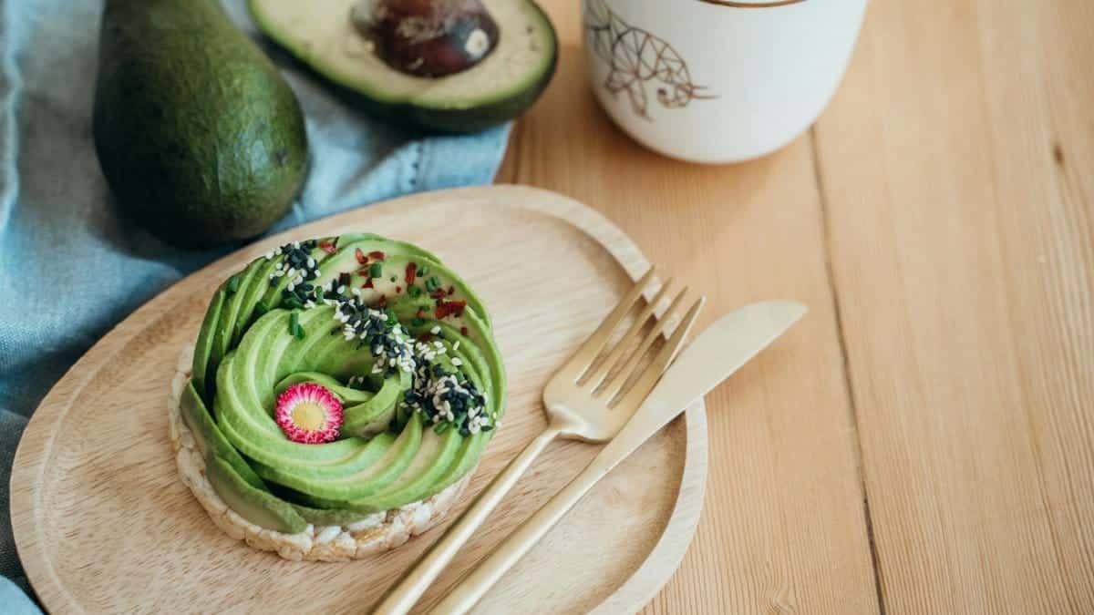 Artistic flatlay of vegan avocado toast with vibrant toppings, perfect for healthy breakfasts.