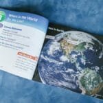 An open educational book displaying a world map and lesson outcomes about global locations.