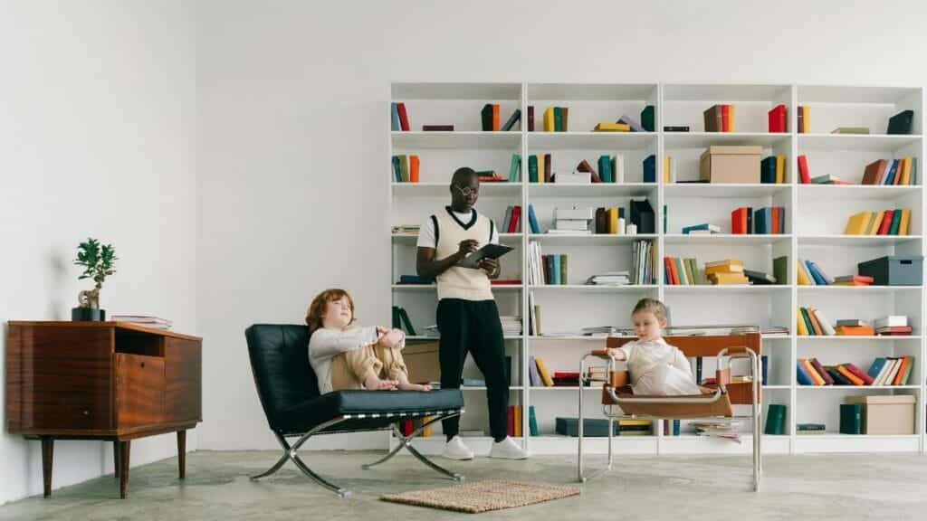 Psychologist conducts a therapy session with children in a modern library setting.