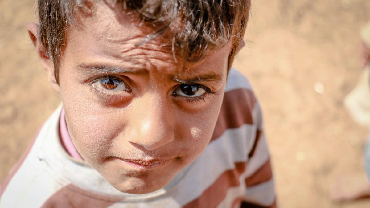 Close-up shot of a young boy in Idlib, capturing innocence in a crisis setting.
