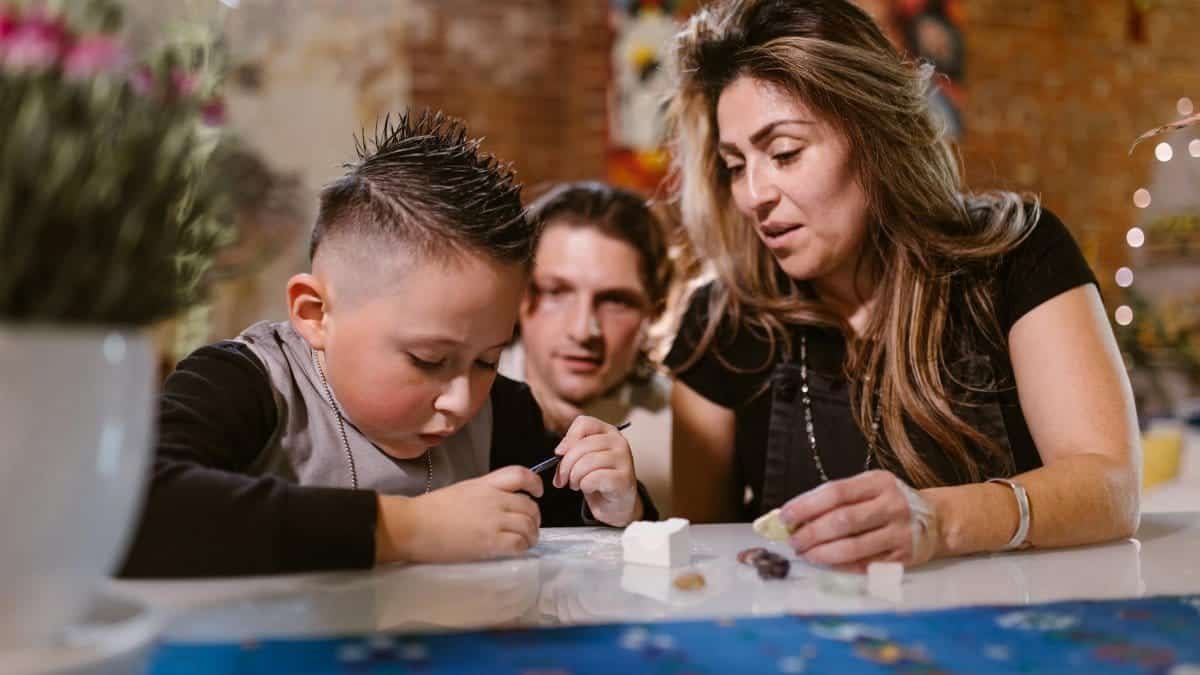 A family enjoying quality time creating art and crafts together indoors.
