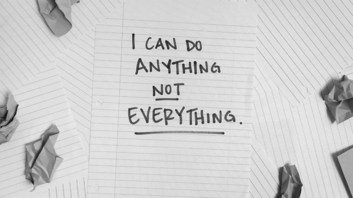 A motivational message on paper surrounded by crumpled sheets, symbolizing focus amidst chaos.