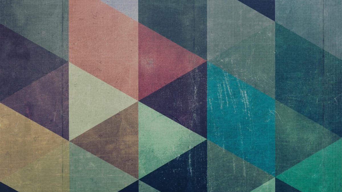 A vibrant geometric abstract design featuring multicolored triangles with a textured, artistic finish.