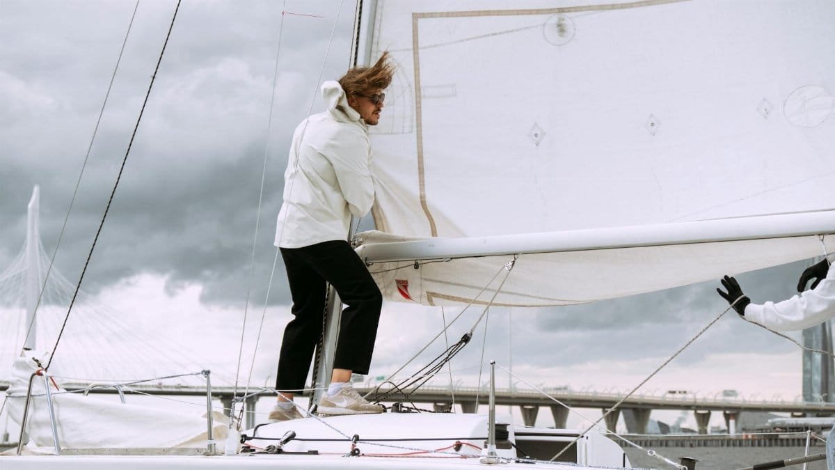 Yachtsman sailing on a breezy day with dramatic skies.