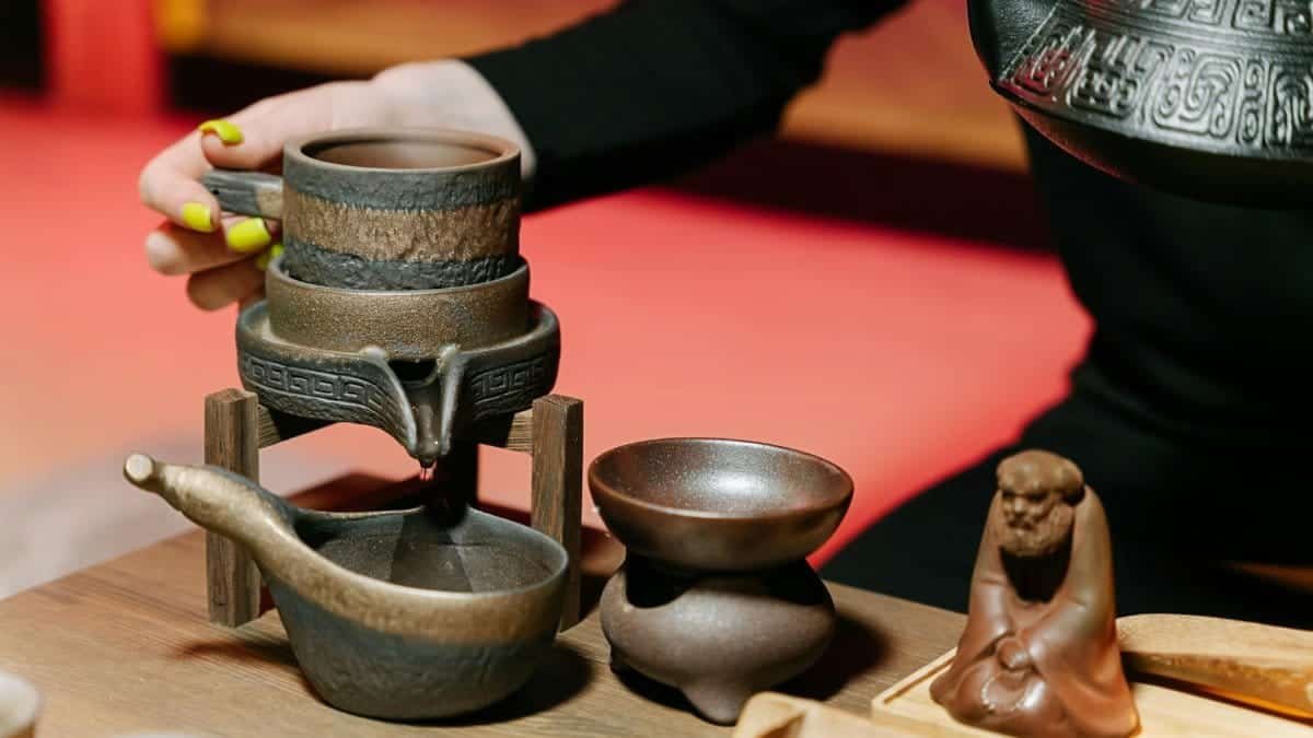 Elegant tea ceremony setting with teapot and traditional accessories, emphasizing cultural heritage.