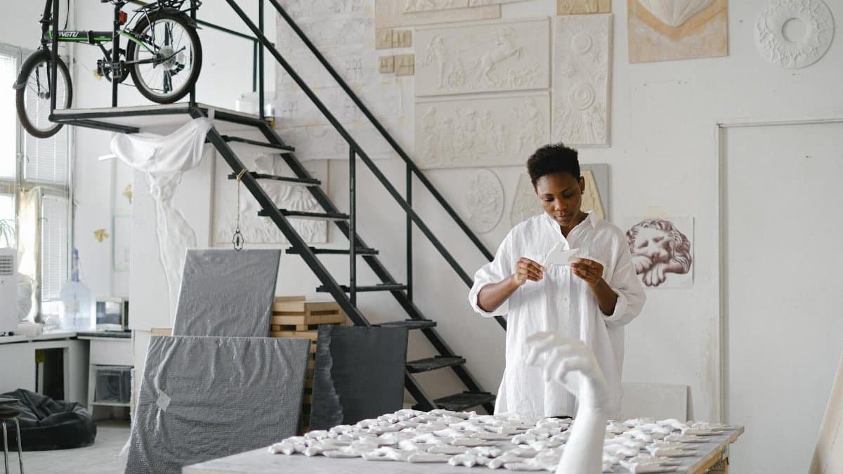 A skilled female artisan working with ceramics in a creative studio environment.