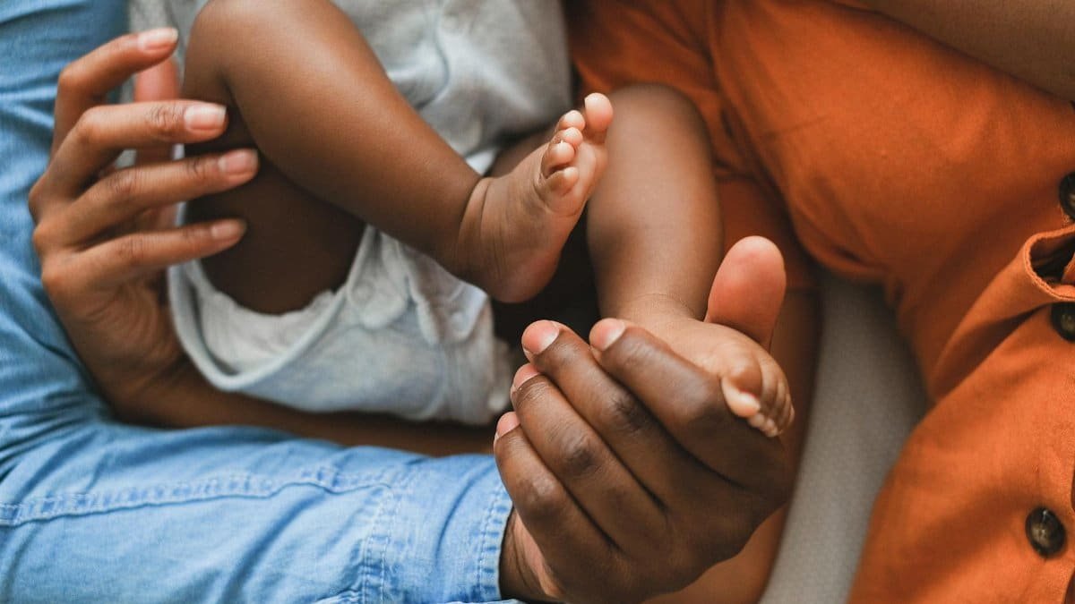 Close-up of a family holding a baby, showcasing love and connection.
