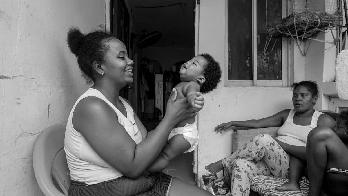 A joyful family moment captured indoors with a mother and child.