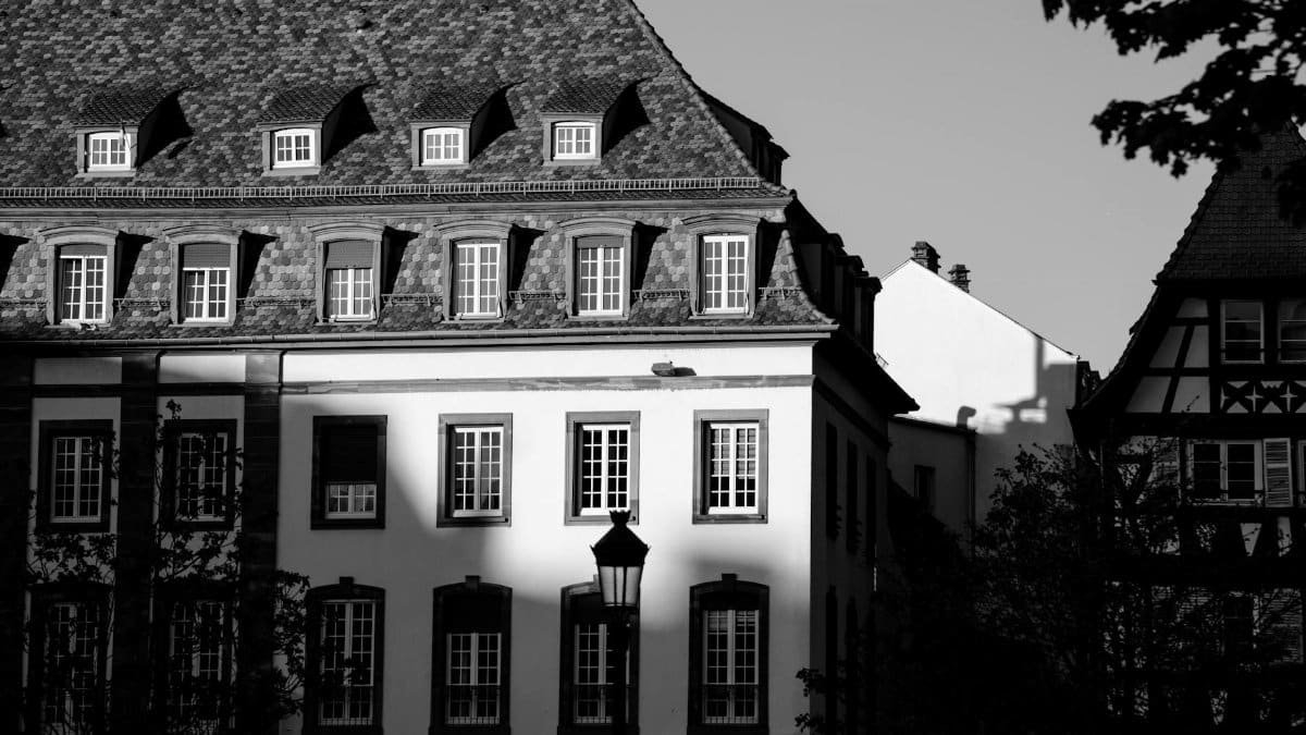 Black and white photo of classic Strasbourg buildings highlighting European architectural elegance.