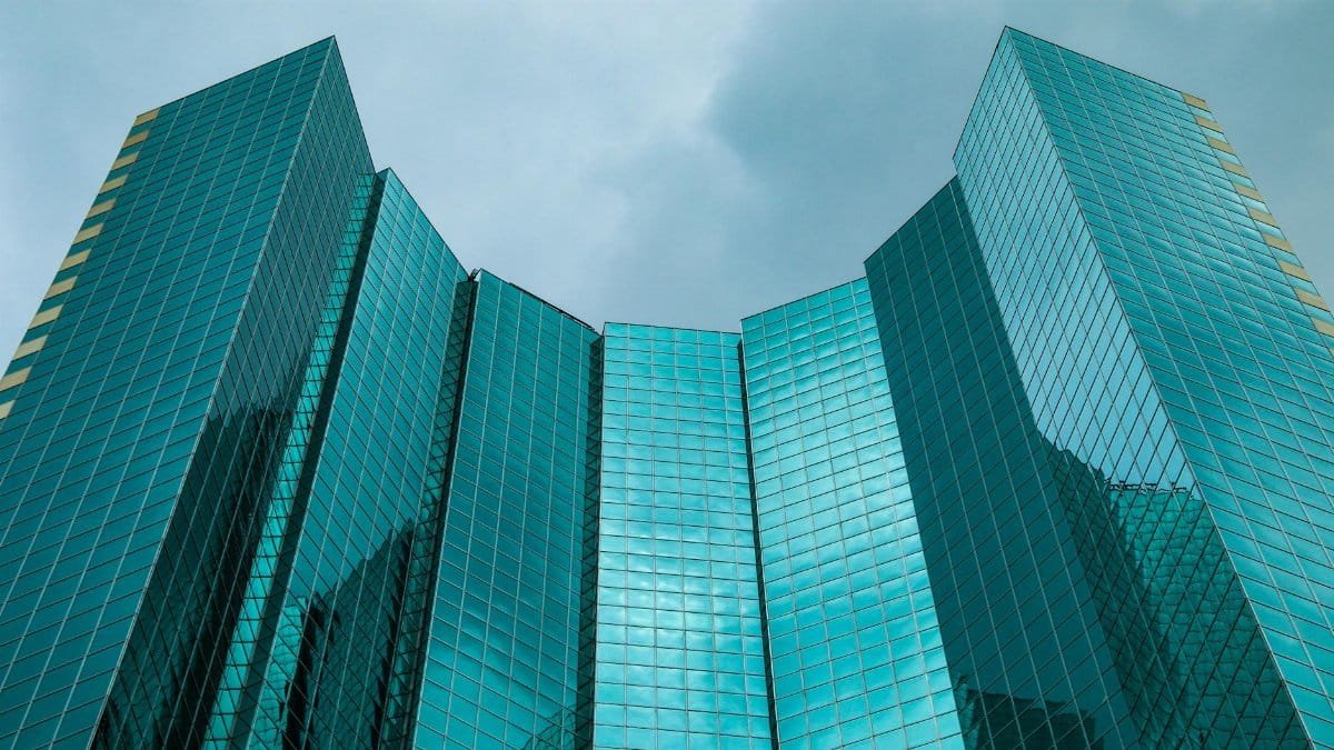 Low angle view of reflective glass skyscraper in Denver's city center.