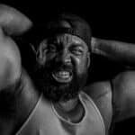 Powerful black and white portrait of a bodybuilder showcasing strength and determination.