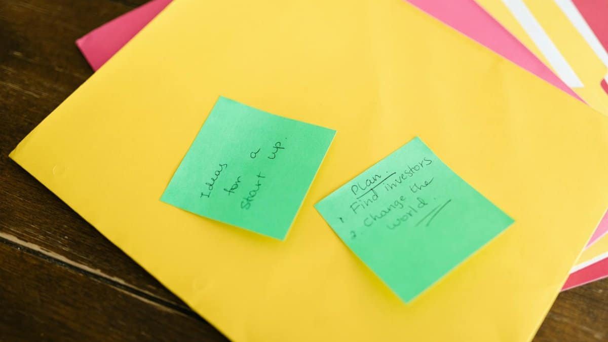 Vibrant sticky notes with startup ideas and plans placed on a desk.
