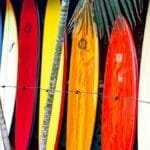 Vibrant surfboards on display at a surf shop in Haleiwa, Hawaii, showcasing tropical colors.