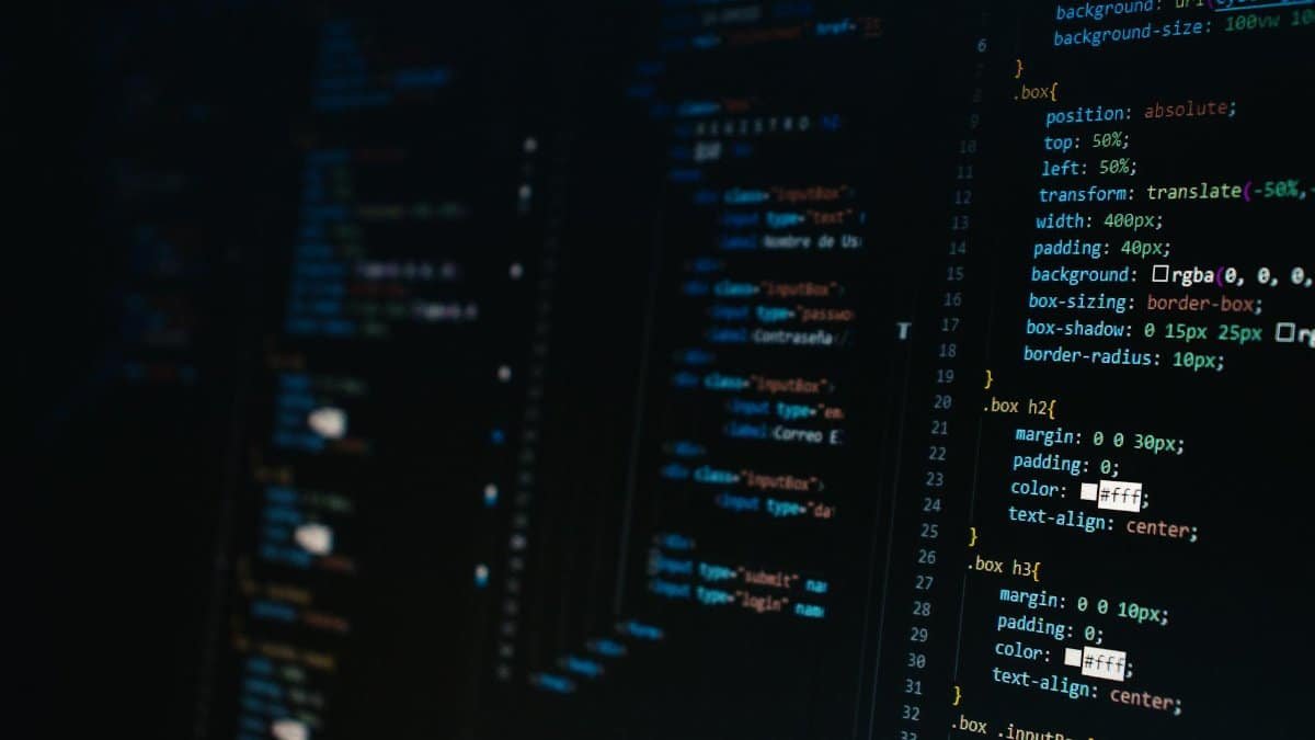 Detailed view of HTML and CSS code on a dark screen, representing modern web development.
