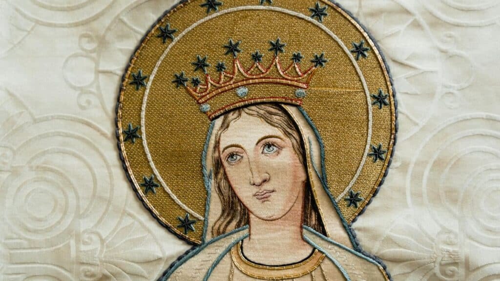 Beautifully detailed religious embroidery depicting a holy figure adorned in gold and stars.