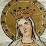Beautifully detailed religious embroidery depicting a holy figure adorned in gold and stars.