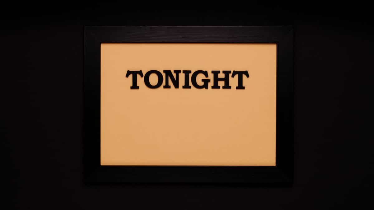 Minimalist framed sign with the word 'Tonight' on a solid black background.