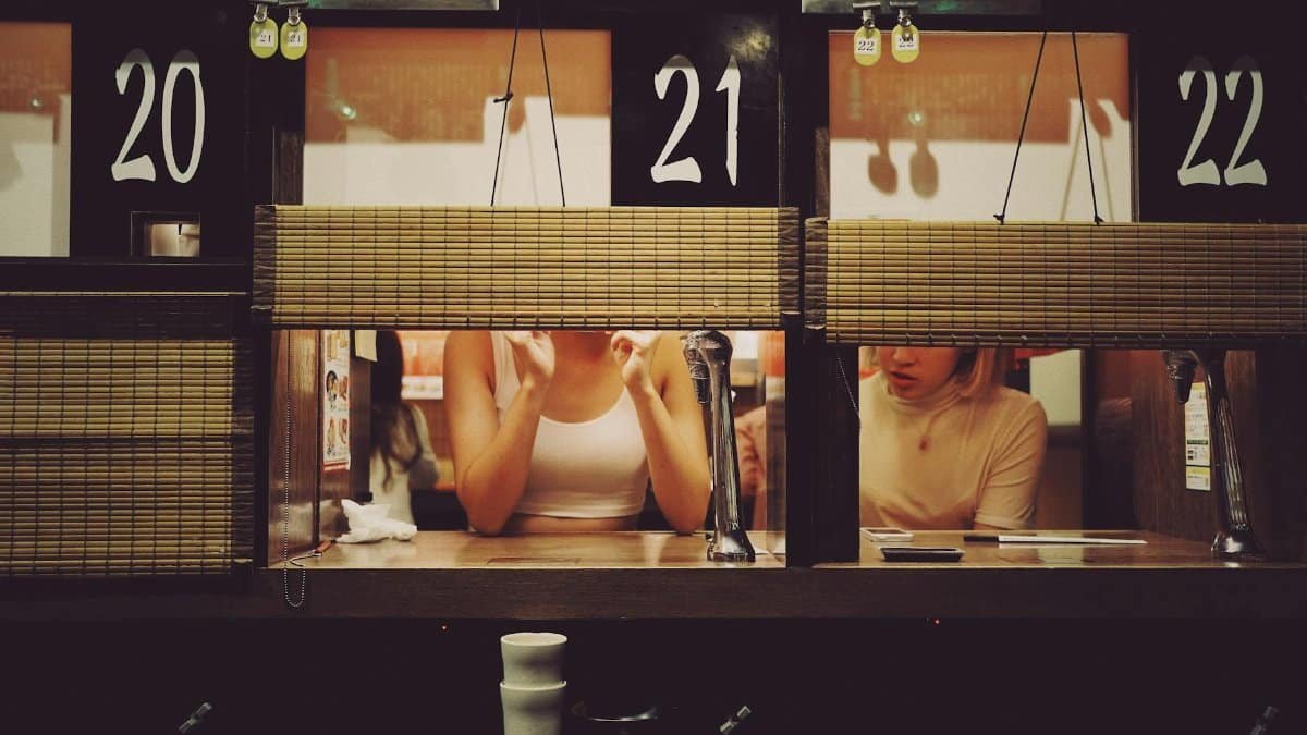 Intimate dining experience at a ramen restaurant in Shibuya, Tokyo with individual booths.