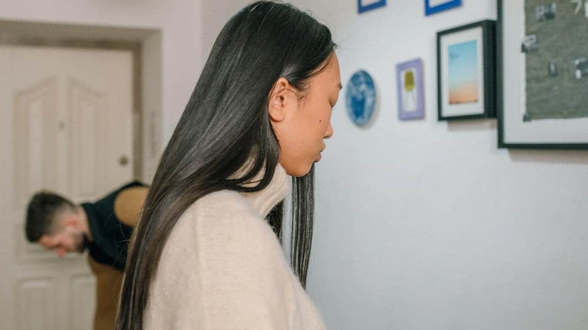 A couple in a modern apartment experiencing emotional tension, highlighting relationship struggles.