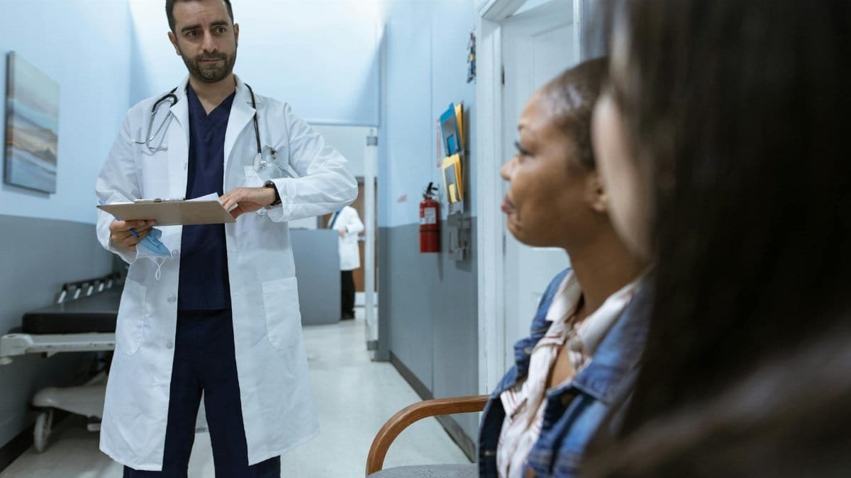Doctor in a healthcare setting consulting patients, promoting health and wellness.