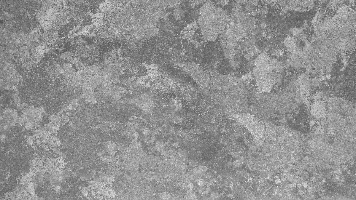 Close-up of a gray cement wall with rough, textured surface ideal for backgrounds.