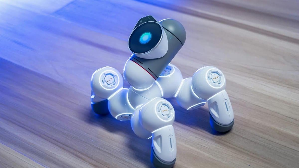 Close-up of a modern robotic toy with glowing features on a wooden floor, showcasing innovative technology.
