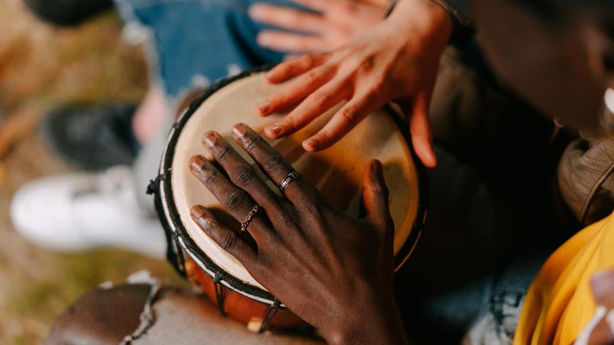 A top view of hands playing a drum, showcasing cultural unity and musical expression.