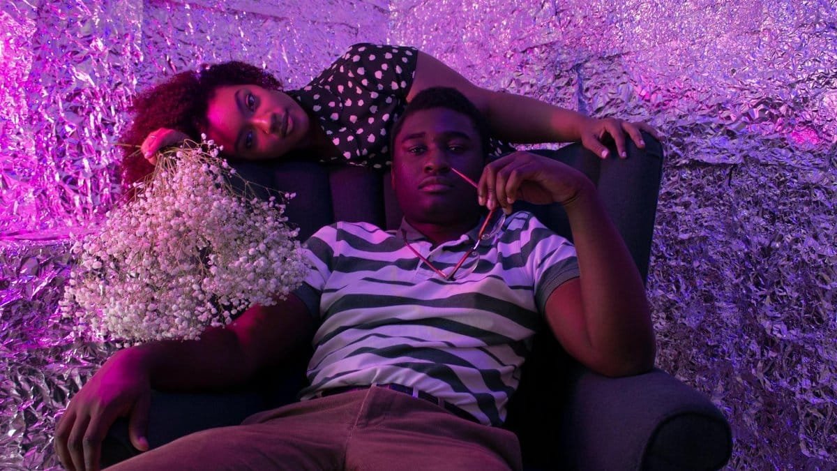 Creative portrait with neon lighting featuring a man and woman in a modern setting.