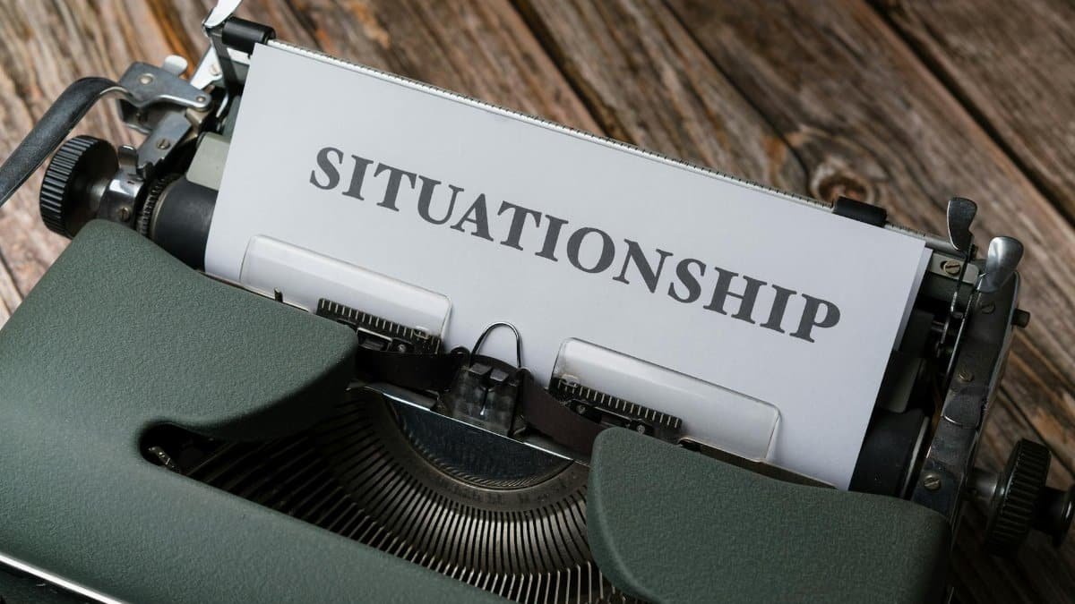 Close-up of a vintage typewriter with "Situationship" typed on paper, symbolizing modern dating concepts.