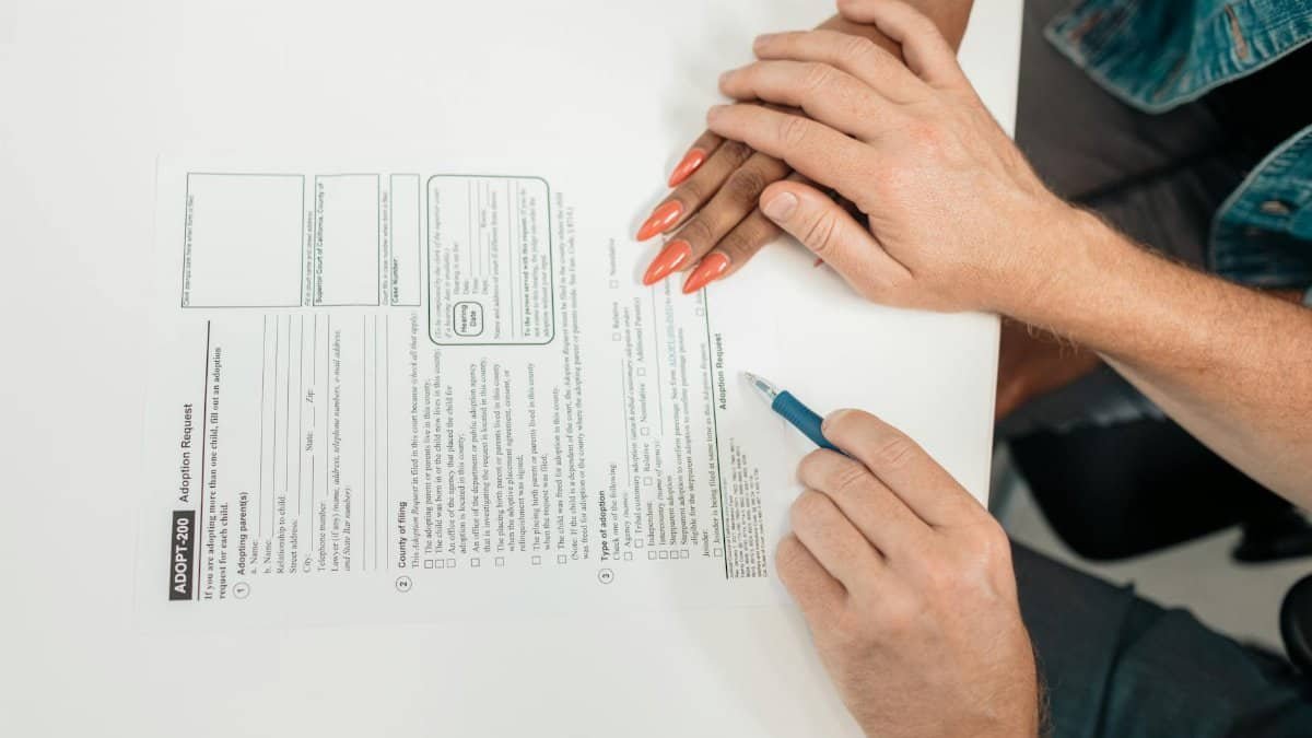 A couple fills out an adoption request form, highlighting commitment and future family planning.