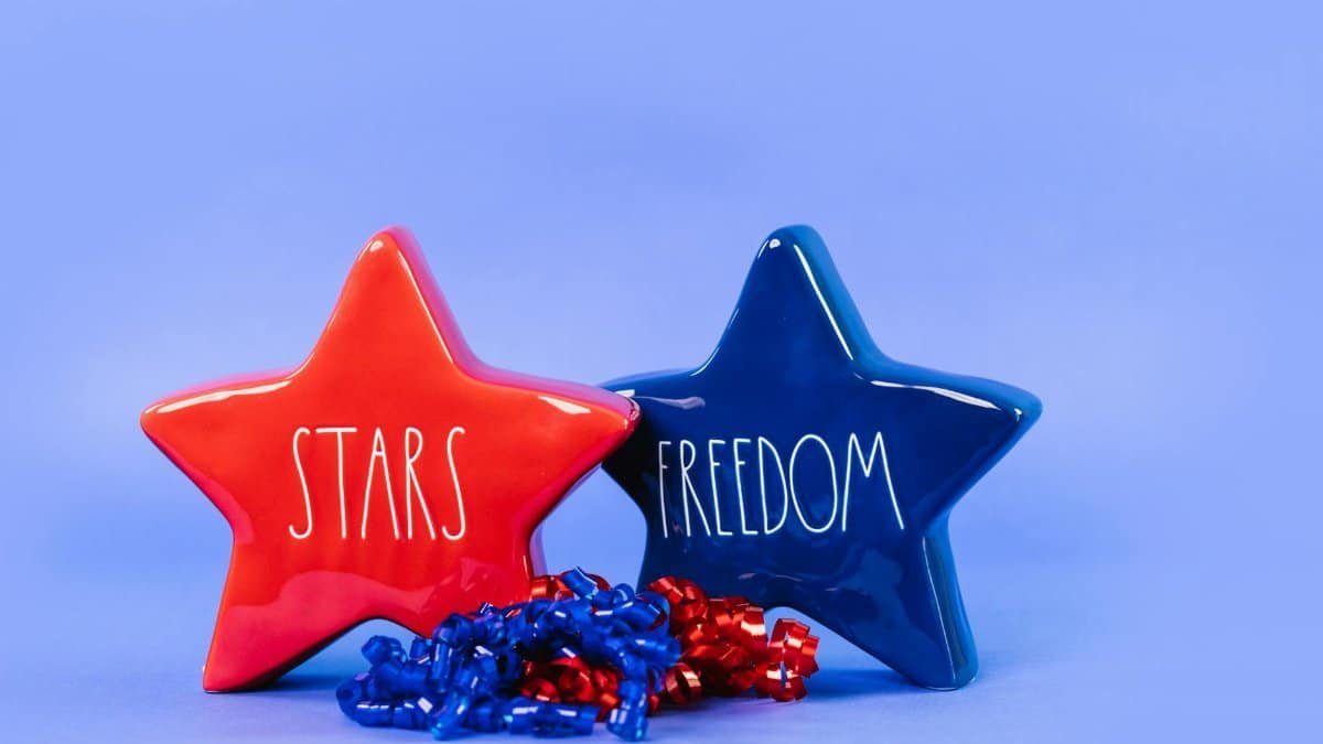 Red and blue star-shaped figurines with text 'STARS' and 'FREEDOM' on a blue background.