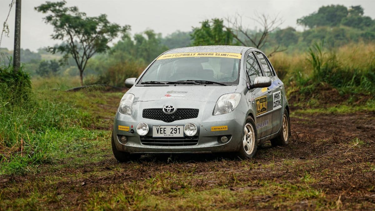 A Toyota rally car navigating through muddy terrain in Baras, Philippines, showcasing off-road racing.