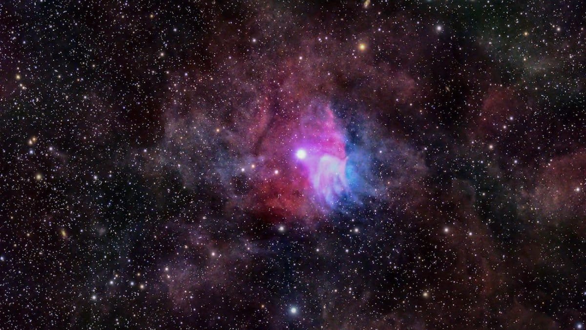 Colorful nebula and star-filled night sky captured with astrophotography.