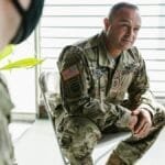 Military veterans participate in a group therapy session to support mental health recovery.