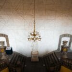 Majestic museum staircase in Mexico City with grand chandelier and statue.