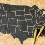 Two cannabis joints placed over a USA map, symbolizing marijuana legalization.