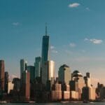 Stunning view of New York City skyline during sunset, highlighting iconic skyscrapers.