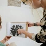 Therapist discussing Rorschach inkblot test with a client in a therapy session.