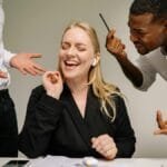 Conceptual image of office conflict with a woman facing workplace pressure surrounded by colleagues.