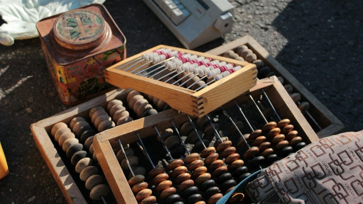 Collection of vintage abacuses and retro items on a sunlit surface.