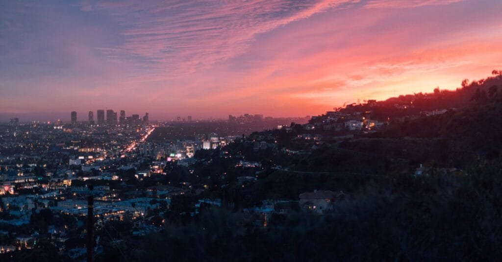 Capture of the vibrant Los Angeles skyline under a dramatic sunset sky via Pexels