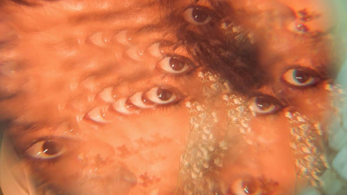 A surreal abstract portrait with a kaleidoscope of multiple eyes, evoking a sense of dreamlike fantasy.