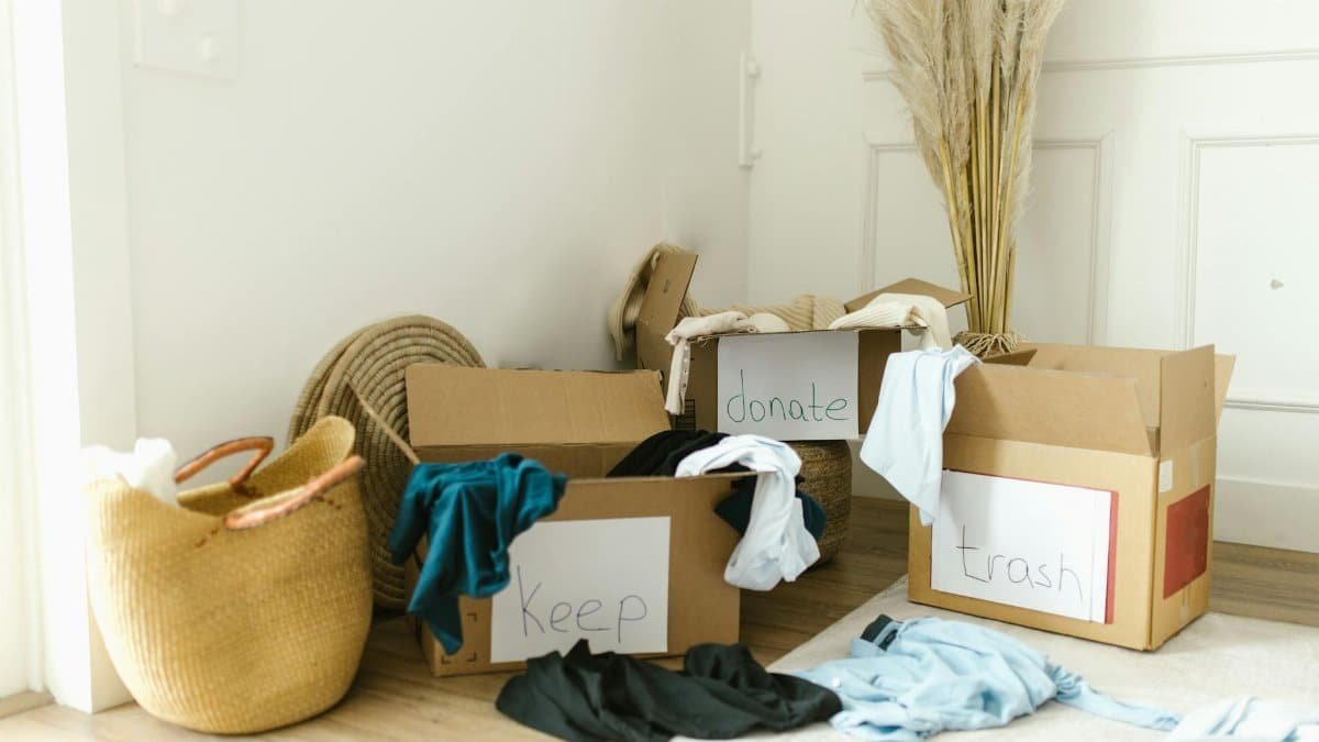 Cardboard boxes labeled 'Keep', 'Donate', and 'Trash' for home decluttering.