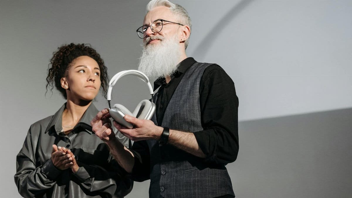 Man and woman presenting new headphone design at a business event.