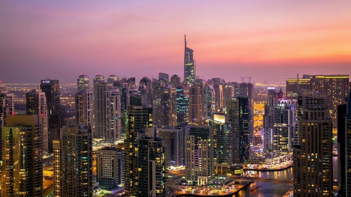Captivating view of Dubai's skyline at dusk with vibrant city lights and skyscrapers.